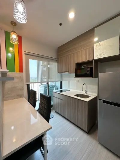 Modern kitchen with sleek cabinetry and breakfast bar in a stylish apartment