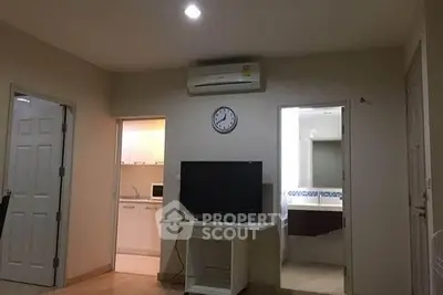 Cozy apartment interior with living room, kitchen, and bathroom access, featuring modern amenities.