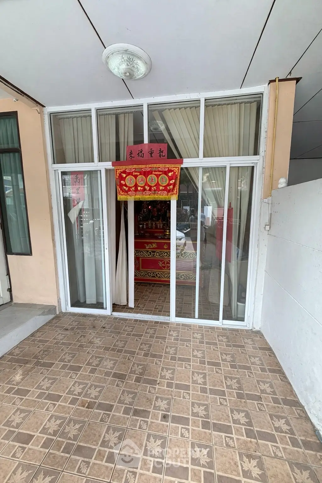 Charming entrance with sliding glass doors and tiled flooring, perfect for welcoming guests.
