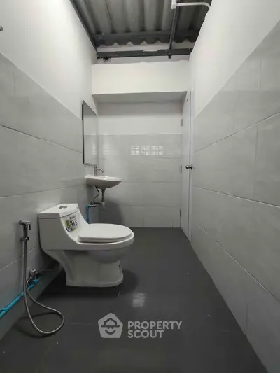 Minimalist bathroom with modern fixtures and sleek tile design.
