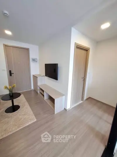 Modern living room with wooden flooring and minimalist furniture design.