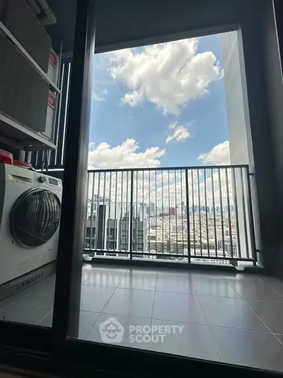 Stunning high-rise balcony with panoramic city view and laundry area.