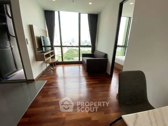 Modern living room with hardwood floors and city view