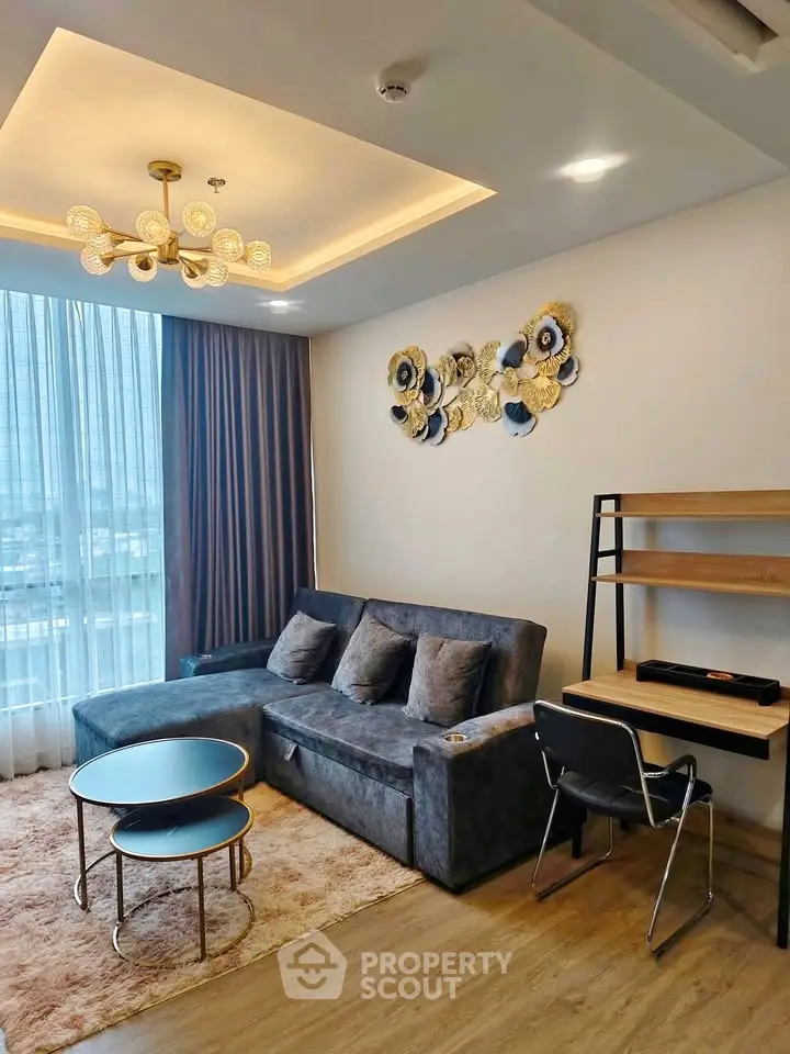 Modern living room with stylish decor, plush sofa, and elegant lighting in a high-rise apartment.