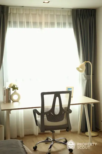 Modern study room with sleek desk and ergonomic chair by a large window.