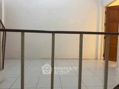 Minimalist interior with tiled floor and wooden door, perfect for modern living.