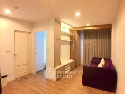Modern living room with purple sofa and wooden flooring in cozy apartment