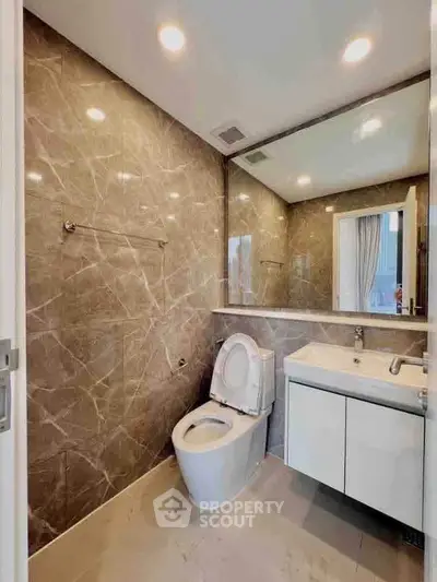 Luxurious modern bathroom with marble walls and sleek fixtures