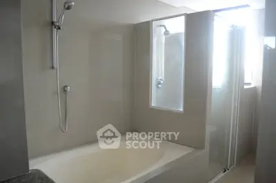 Modern bathroom with bathtub and shower in sleek design