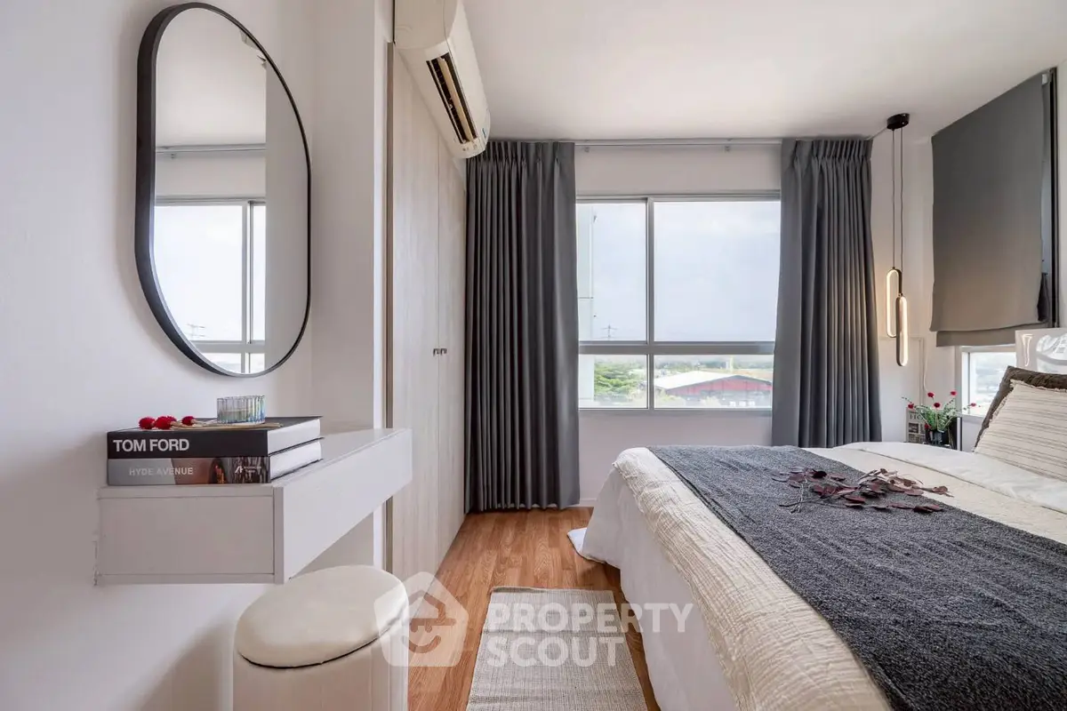 Modern bedroom with stylish decor, large windows, and cozy ambiance.