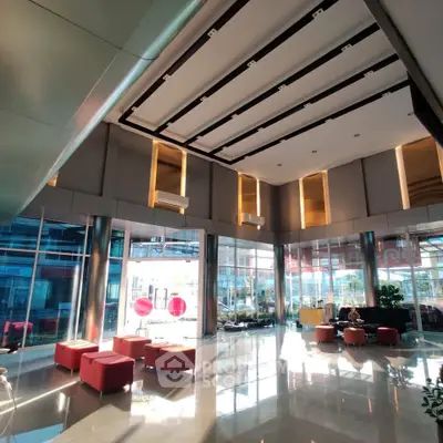 Luxurious modern building lobby with high ceilings and stylish seating area.