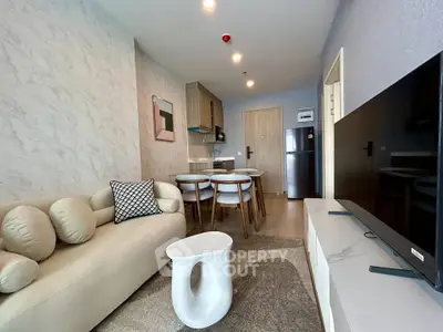 Modern living room with stylish furniture and open kitchen layout in a contemporary apartment.