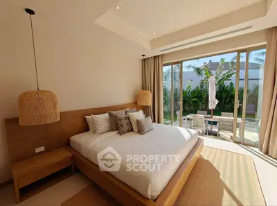 Luxurious bedroom with pool view and modern decor in tropical setting