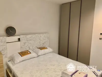 Modern bedroom with stylish marble headboard and sleek wardrobe design.