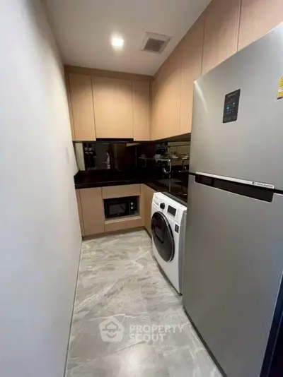 Modern compact kitchen with sleek appliances and stylish cabinetry