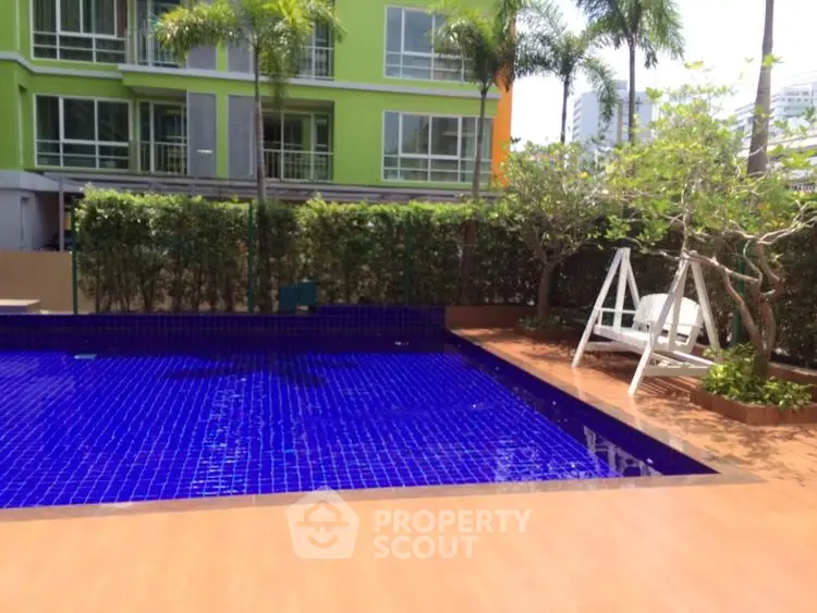 Luxurious residential pool area with modern design and lush greenery.