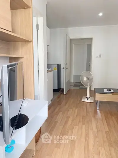 Modern living room with wooden flooring and minimalist furniture