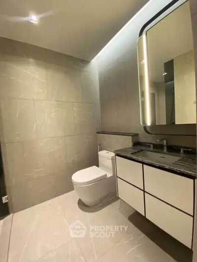 Modern bathroom with sleek design and elegant fixtures in a luxury apartment.