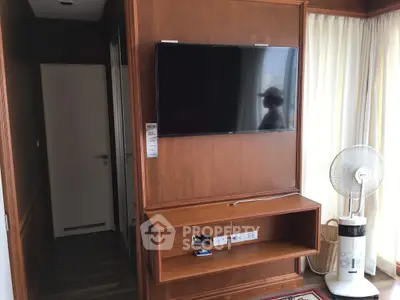 Modern living room with wall-mounted TV and stylish wooden decor