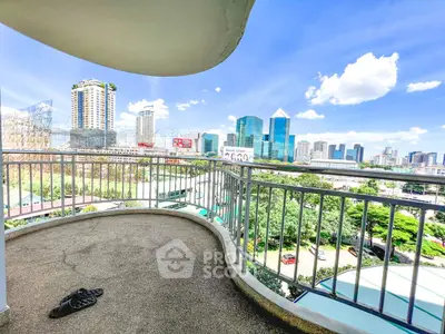 Stunning cityscape view from a spacious balcony in a high-rise apartment.