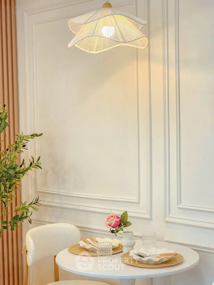 Chic dining nook with elegant lighting and modern decor, perfect for intimate meals.