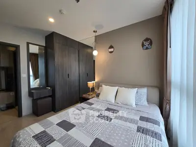 Modern bedroom with stylish decor and ample natural light