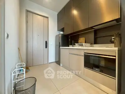 Modern kitchen with sleek cabinetry and built-in appliances in a stylish apartment.