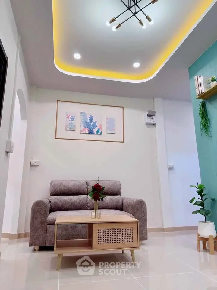 Modern living room with stylish ceiling lights and cozy sofa