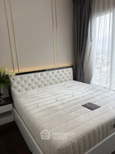 Luxurious bedroom with elegant tufted headboard and city view