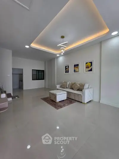 Spacious modern living room with elegant lighting and stylish decor, perfect for relaxation and entertainment.