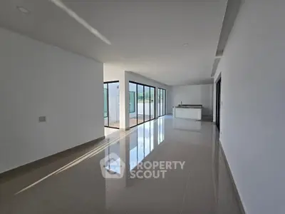 Spacious modern living room with open layout and large windows for natural light.