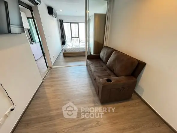 Modern apartment interior with cozy brown sofa and wooden flooring