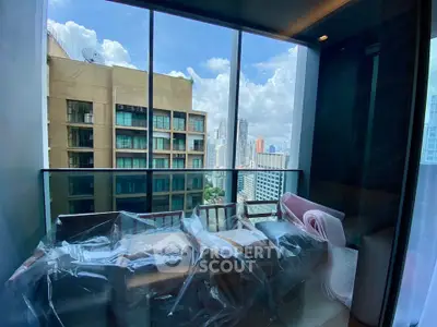 Modern balcony with city view and wrapped furniture in high-rise apartment