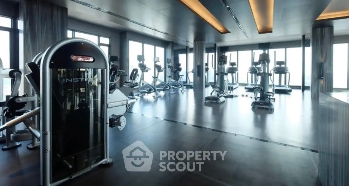 Luxurious modern gym with panoramic city views and state-of-the-art equipment.