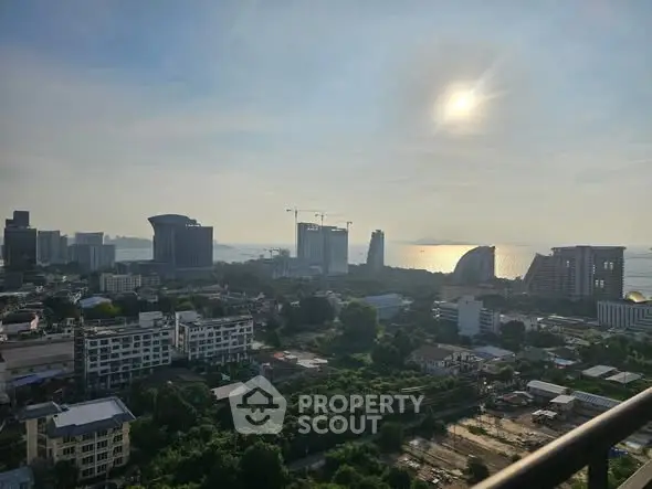 Stunning cityscape view with ocean horizon and modern skyline at sunset.