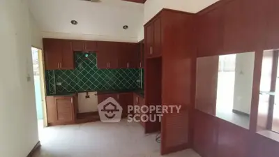 Spacious kitchen with elegant wooden cabinets and green tile backsplash