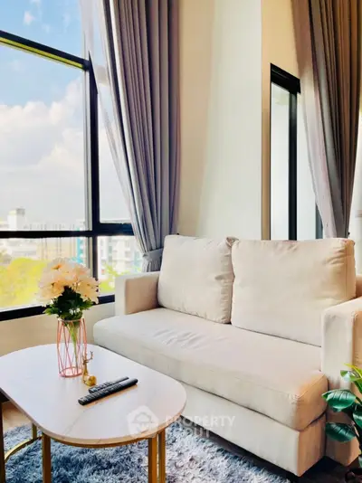 Bright and cozy living room with large windows and modern decor