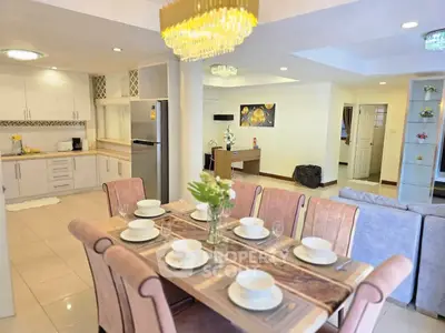 Spacious open-plan living and dining area with modern kitchen and elegant decor.