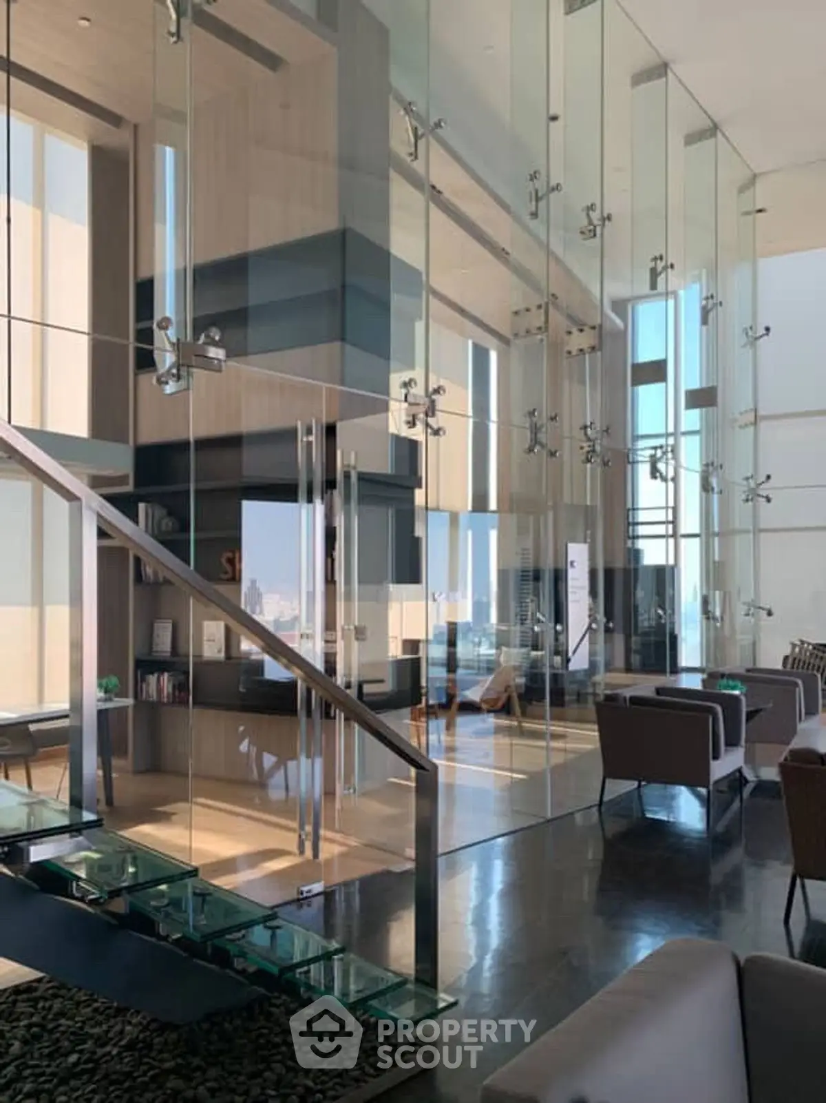 Luxurious modern living room with glass walls and sleek staircase