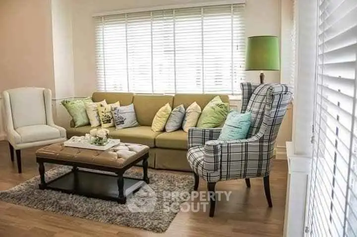 Charming living room with cozy seating and stylish decor, perfect for relaxation and entertaining.