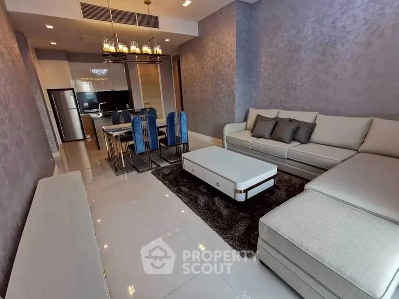 Luxurious modern living room with elegant dining area and sleek kitchen.
