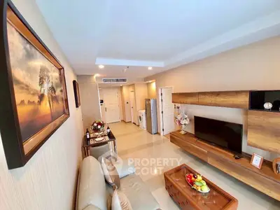 Modern living room with elegant decor and spacious layout, featuring a stylish TV unit and cozy seating area.