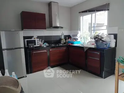 Modern kitchen with sleek cabinets and stainless steel appliances in a cozy home setting.
