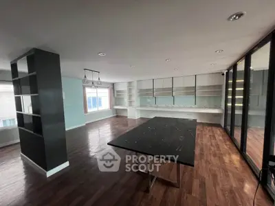 Spacious modern living room with hardwood floors and large windows