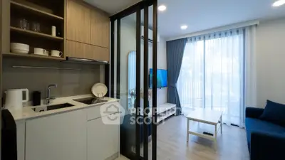 Modern open-layout kitchen and living room with sleek design and natural light