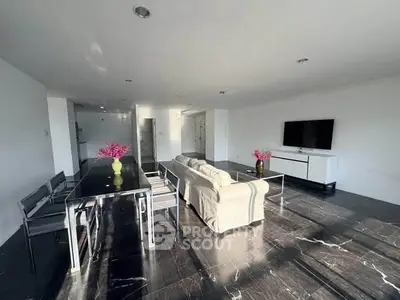 Spacious modern living room with sleek black marble flooring and stylish furniture, perfect for entertaining.