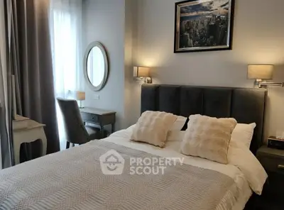 Cozy bedroom with elegant decor, featuring a plush bed, stylish lamps, and a chic vanity desk.