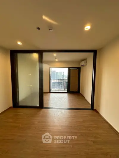 Spacious modern apartment with wooden flooring and balcony view