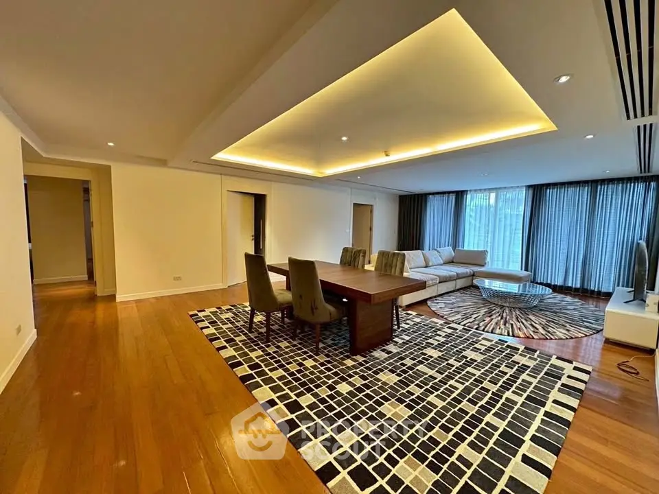 Spacious modern living room with elegant lighting and hardwood floors