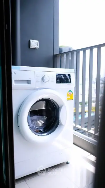 Modern washing machine on a sleek balcony with city view, perfect for urban living.